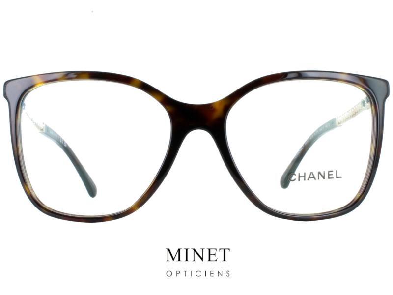 La monture optique Chanel 3441-Q-H est une paire de lunettes pour femmes, de forme carrée, qui affiche une grande finesse dans sa conception. La face est réalisée en acétate de haute qualité, qui offre une grande résistance et un toucher doux, et qui s'adapte parfaitement à la forme du visage. La monture est assez grande, ce qui permet de bien couvrir l'œil et d'offrir une bonne perception du champs visuel. Les branches sont quant à elles en métal doré et sont assez fines. La première partie des branches est recouverte d'un lacet de cuir, ce qui donne une touche d'originalité et de modernité à la monture. Les deux tiers restants des branches sont quant à eux décorés d'une rangée de perles, qui sont un des ornements préférés de Coco Chanel. Cette touche de fantaisie et de féminité vient apporter une touche supplémentaire à la monture, qui se distingue ainsi par son élégance et son originalité.